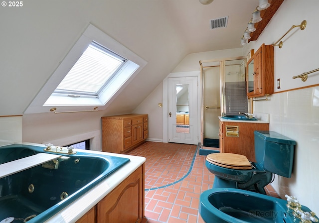 full bathroom featuring toilet, separate shower and tub, lofted ceiling with skylight, sink, and a bidet