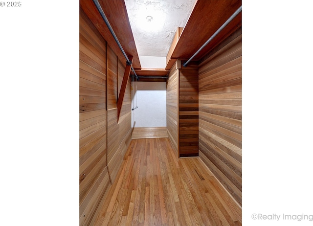 spacious closet with light hardwood / wood-style floors