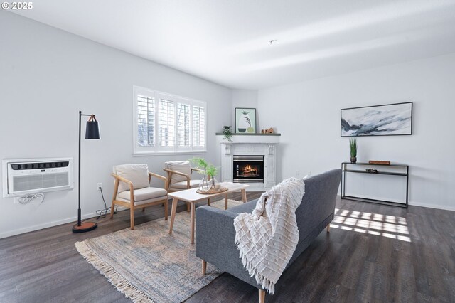 living room featuring dark hardwood / wood-style floors and an AC wall unit