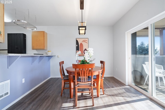 dining area with dark hardwood / wood-style floors