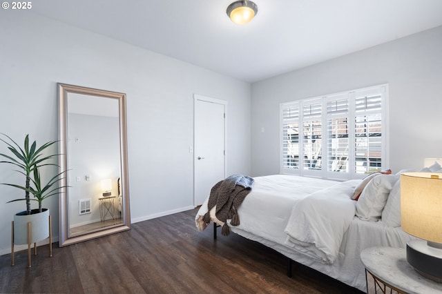 bedroom with dark hardwood / wood-style floors