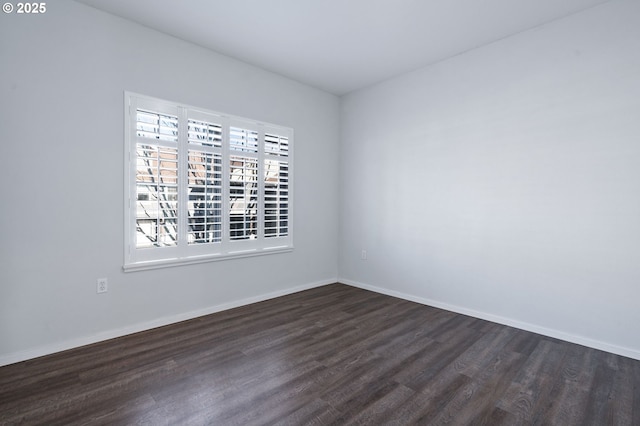 spare room featuring dark hardwood / wood-style flooring