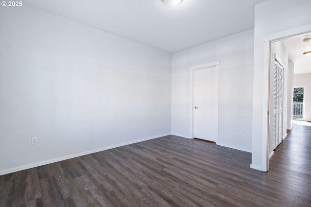 empty room with dark wood-type flooring