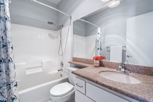 full bathroom with vanity, shower / bath combo with shower curtain, and toilet