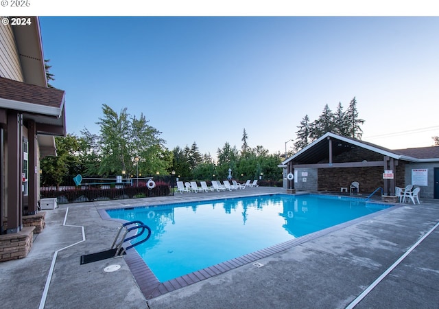 view of pool at dusk