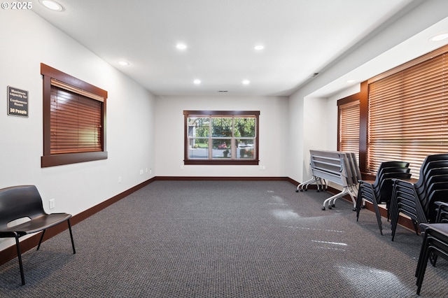 sitting room featuring dark colored carpet