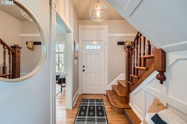 entrance foyer with light wood-type flooring and stairs