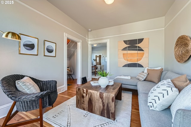 living room with baseboards and wood finished floors