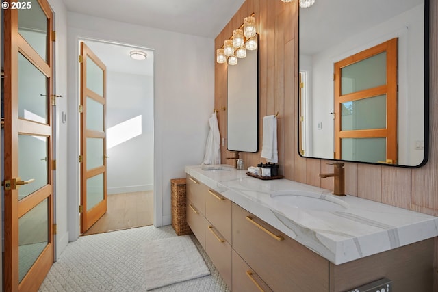 full bathroom with a sink and double vanity