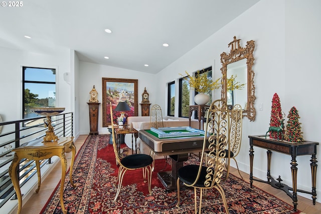 dining space featuring baseboards, recessed lighting, wood finished floors, and lofted ceiling