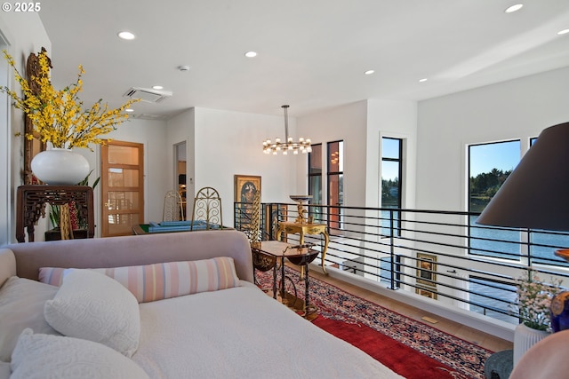 bedroom with recessed lighting, visible vents, wood finished floors, and an inviting chandelier