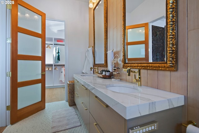 full bathroom with a sink and double vanity