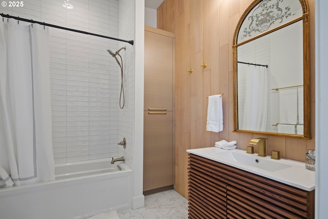 bathroom featuring vanity, wood walls, and shower / tub combo