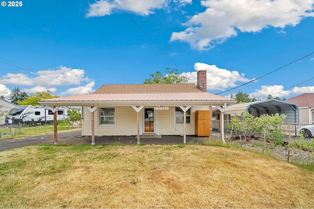 4616 SE 128th Ave, Portland, OR 97236 - view of front of house with a detached carport, a chimney, asphalt driveway, and covered porch