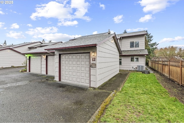 exterior space with a garage and a lawn