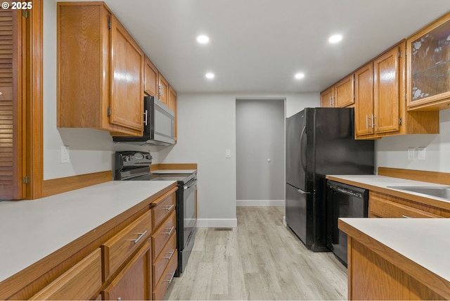434 SW Eastman Pkwy, Gresham, OR 97080 - kitchen featuring black appliances, recessed lighting, light countertops, light wood-type flooring, and brown cabinets