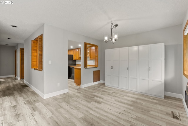 434 SW Eastman Pkwy, Gresham, OR 97080 - unfurnished living room with light wood-type flooring, a textured ceiling, a chandelier, baseboards, and recessed lighting