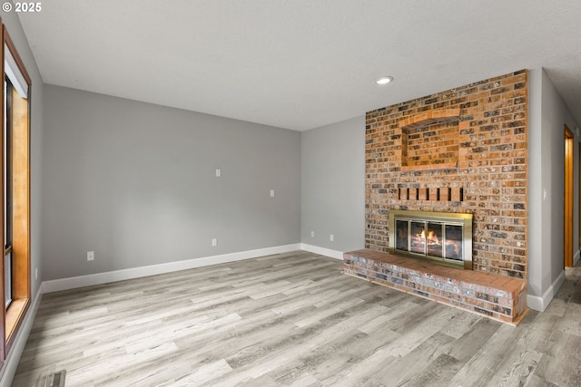 434 SW Eastman Pkwy, Gresham, OR 97080 - unfurnished living room featuring wood finished floors, baseboards, recessed lighting, and a fireplace
