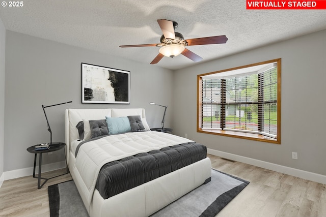 434 SW Eastman Pkwy, Gresham, OR 97080 - bedroom featuring light wood finished floors, a textured ceiling, baseboards, and a ceiling fan