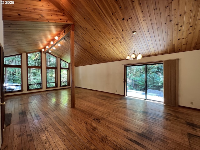 42250 Cedar Hollow Rd, Port Orford, OR 97465 - unfurnished living room featuring a chandelier, healthy amount of natural light, vaulted ceiling, wood ceiling, and baseboards