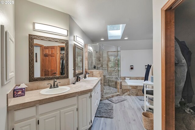 19642 SW 56th Ct, Tualatin, OR 97062 - bathroom with a skylight, wood finished floors, a stall shower, a bath, and double vanity