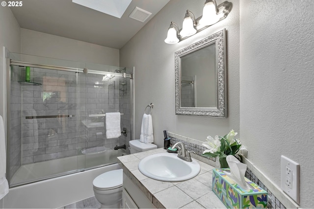 19642 SW 56th Ct, Tualatin, OR 97062 - bathroom featuring toilet, vanity, bath / shower combo with glass door, and a textured wall