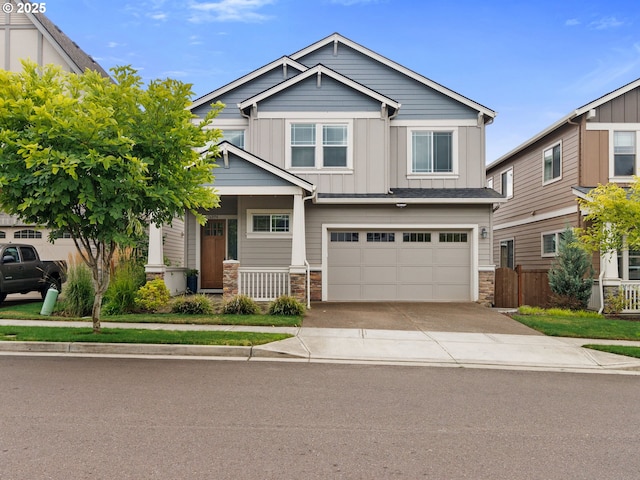 craftsman inspired home with a garage and covered porch