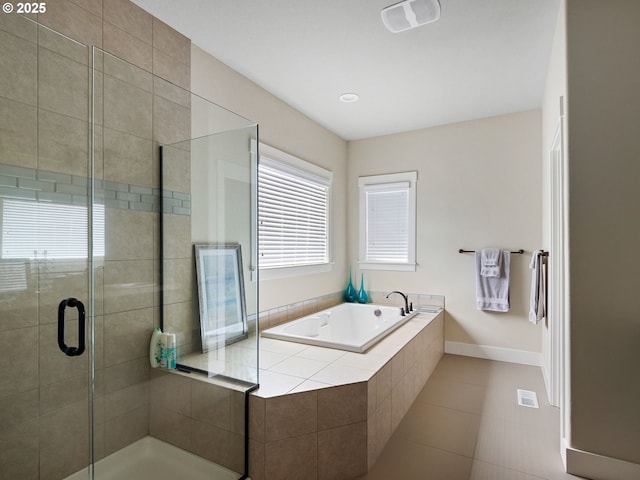 bathroom with independent shower and bath and tile patterned floors