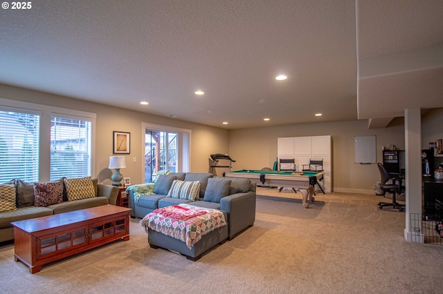 living room with a healthy amount of sunlight, light colored carpet, a textured ceiling, and billiards