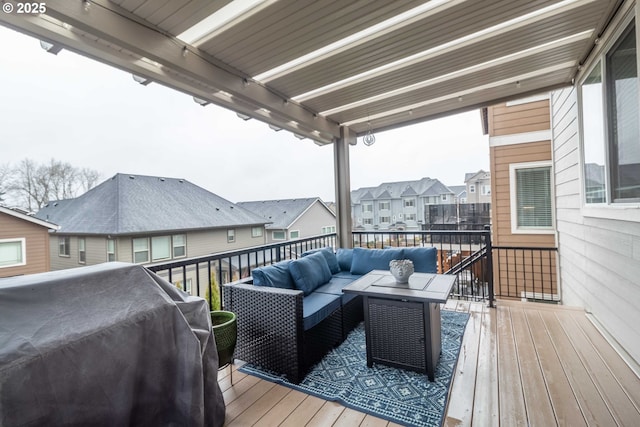 wooden deck featuring a grill and an outdoor living space