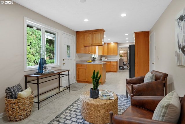 living area with recessed lighting and light tile patterned floors