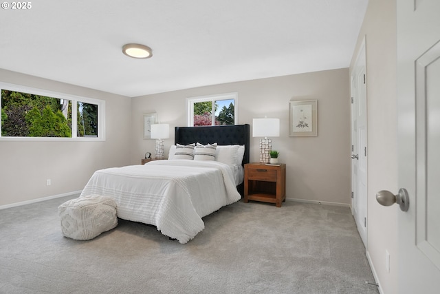 carpeted bedroom featuring baseboards