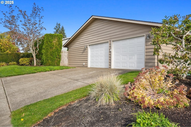 detached garage featuring fence