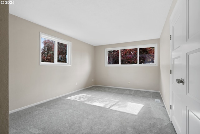 spare room with carpet floors and baseboards