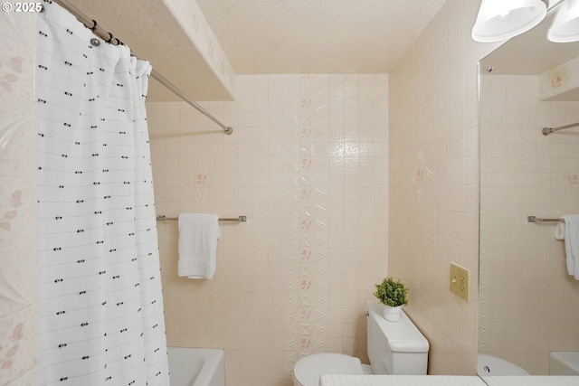 full bathroom with shower / bath combination with curtain, toilet, and tile walls