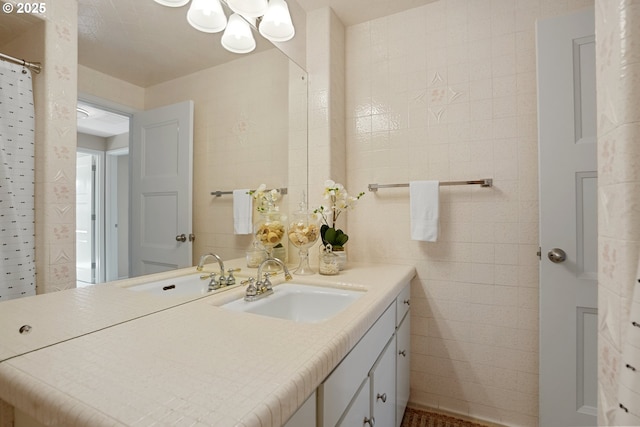 bathroom with vanity and tile walls