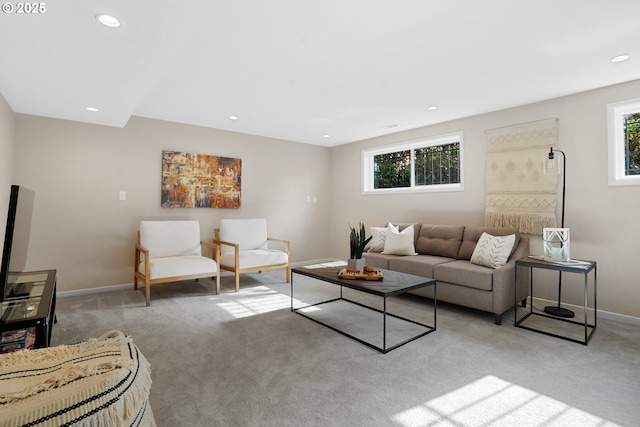 living room featuring baseboards, recessed lighting, and light colored carpet