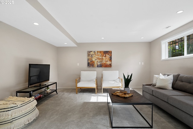 carpeted living area with baseboards and recessed lighting