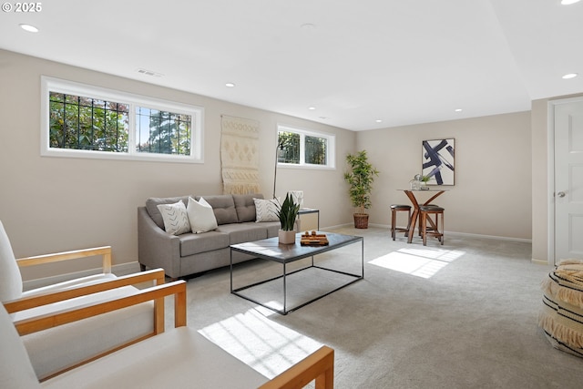 living area featuring recessed lighting, visible vents, baseboards, and light colored carpet