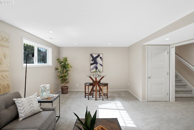 sitting room featuring baseboards, stairway, recessed lighting, and light colored carpet