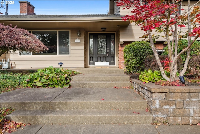 view of exterior entry with brick siding