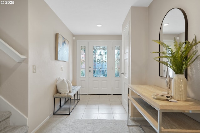 foyer entrance with light tile patterned floors, recessed lighting, light carpet, baseboards, and stairs