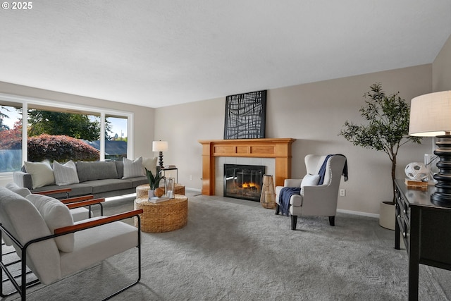 living room featuring baseboards, light colored carpet, and a tiled fireplace