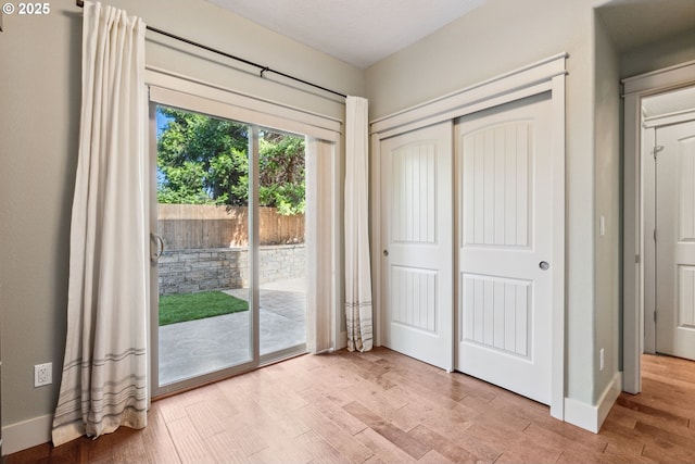 201 Selkirk Ln, Hood River, OR 97031 - unfurnished bedroom with access to outside, a closet, wood finished floors, and baseboards