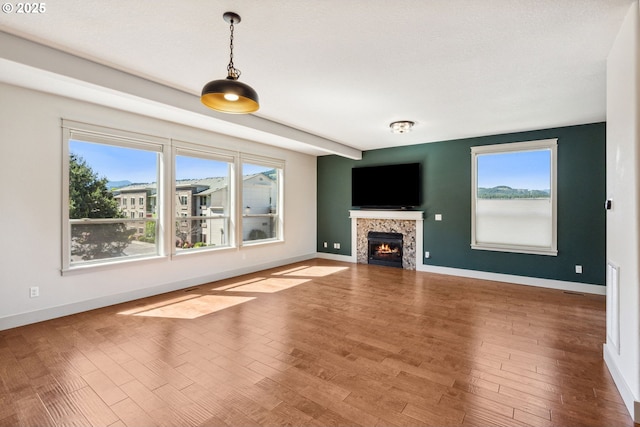 201 Selkirk Ln, Hood River, OR 97031 - unfurnished living room with baseboards, a tiled fireplace, and wood finished floors