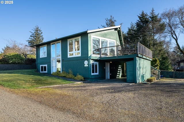 view of front facade featuring a deck and a front yard