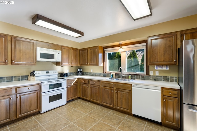 kitchen featuring sink, white appliances, and light tile patterned floors