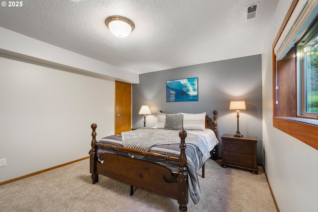 carpeted bedroom with a textured ceiling