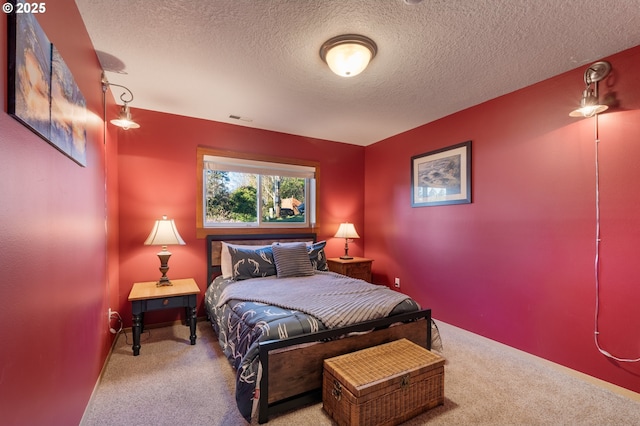 bedroom with a textured ceiling and carpet