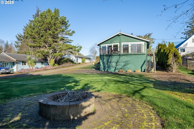 view of yard featuring a wooden deck and an outdoor fire pit